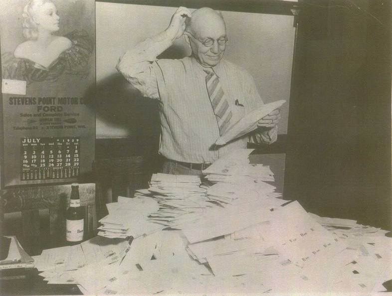 Charles Schenk examines entries from the __name the beer__ contest in 1939.jpg